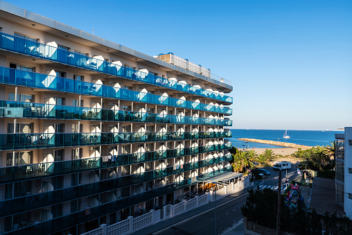 Facade full of balconies of a hotel on the seafront on summer in Salou, Costa Daurada, Tarragona, Catalonia, Spain