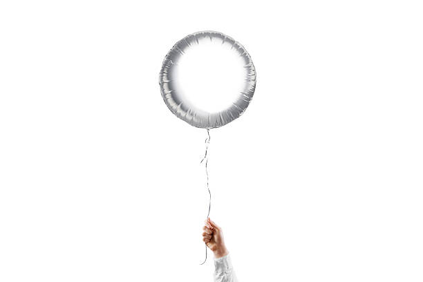 istock Hand holding blank silver round balloon mockup, isolated 2148129390