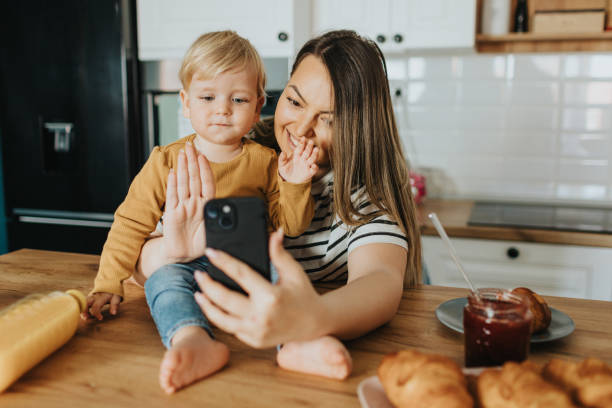 istock Mother and son having video call during breakfast 2148130817