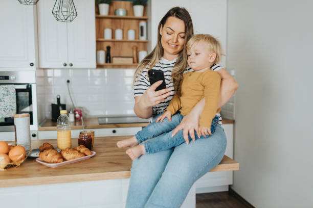 istock Mother and son taking selfie during breakfast at home 2148131211