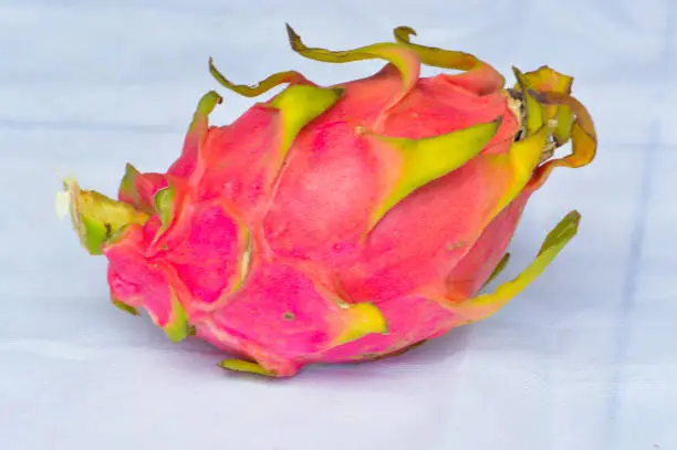 Close-Up Of A Dragon Fruit Or Hylocereus Polyrhizus Against White Background
