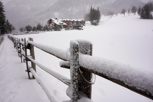 Winter landscape, a wooden fence covered with snow