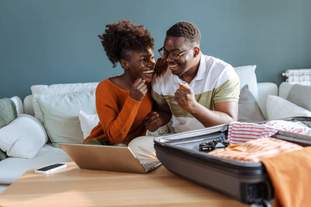 istock African American couple packing for trip and using technology 2148131834