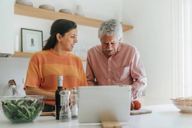 istock Father and daughter cooking following recipe from tablet 2148132399