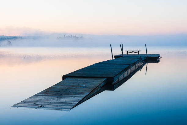 istock Wooden jetty floating on misty lake 2148132755
