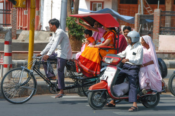 Rajasthan, India - February 26, 2006: Rickshaws and motorbikes on the streets of Jaipur