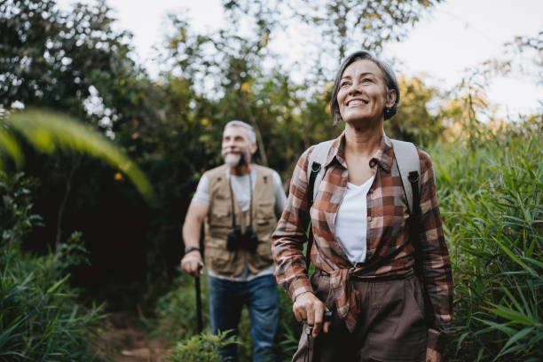 istock Senior couple walking on forest mountain trail 2148133094