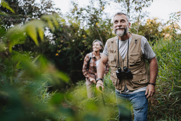 istock Senior couple walking on forest mountain trail 2148133134