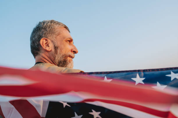 Portrait of a man holding the US national flag stock photo