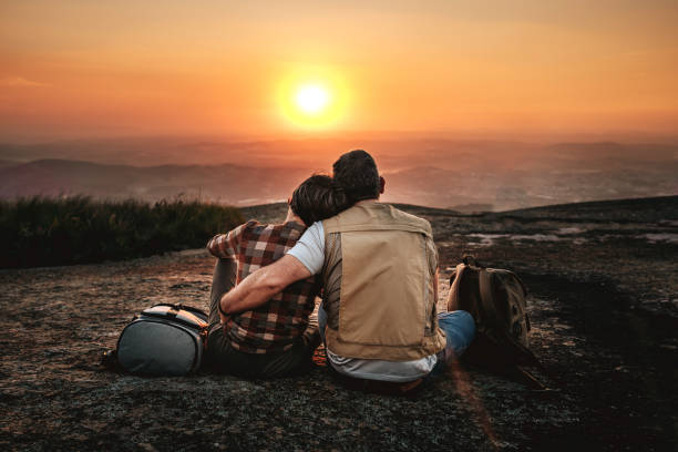 istock Elderly couple hiking in the mountain at sunset 2148133314