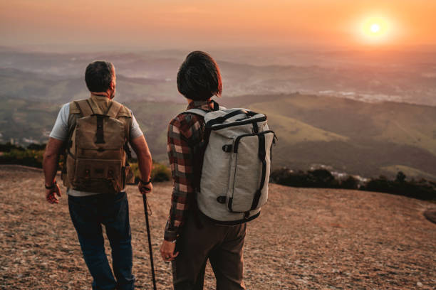 istock Elderly couple hiking in the mountain at sunset 2148133337