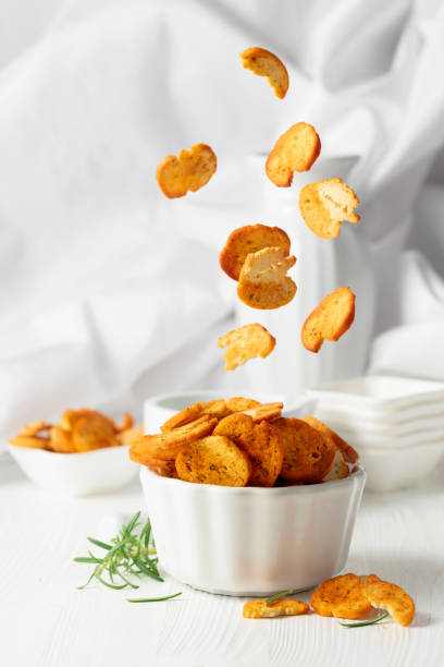 istock Spicy bruschetta crackers with rosemary on a white kitchen table. 2148133491