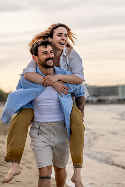 istock Cheerful couple having fun while piggybacking outdoors. 2148133649