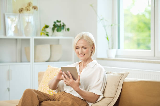 istock Happy mature woman using digital tablet 2148134093