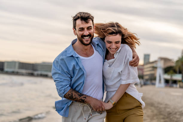 istock Couple walking on the beach 2148134365