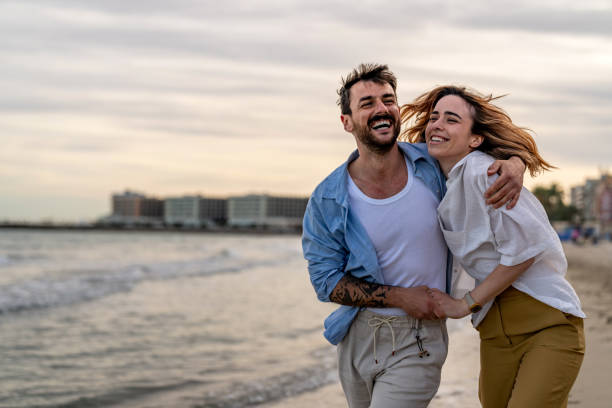 istock Romantic couple walking on sunset beach 2148134419