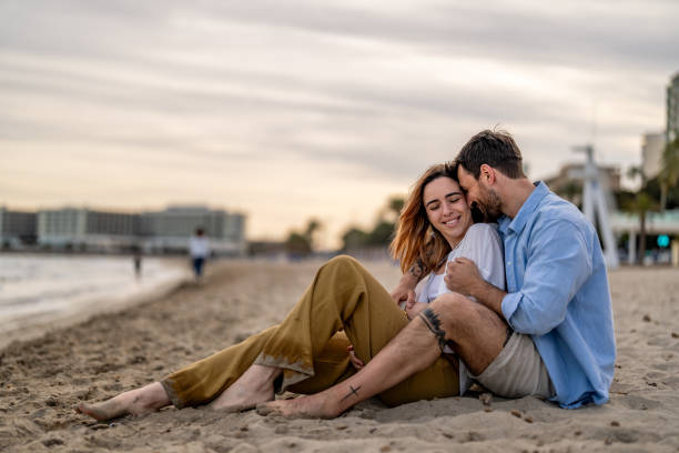 istock Couple siting at the beach on their weekend vacation holiday. 2148135011