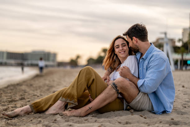 istock Relaxed Couple Siting on the Beach 2148135070