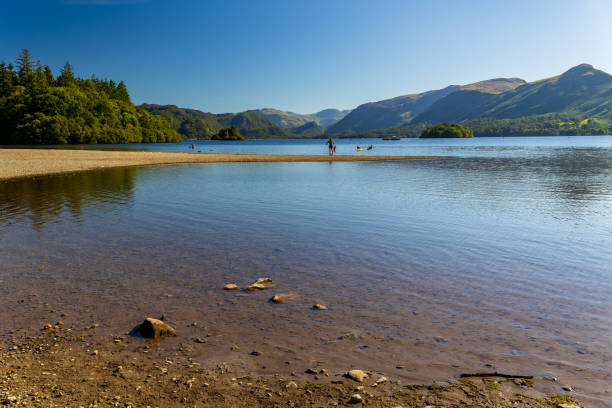 istock Beautiful, tranquil lake with swimmers on a hot summers day (Derwentwater, Lake District) 2148135466