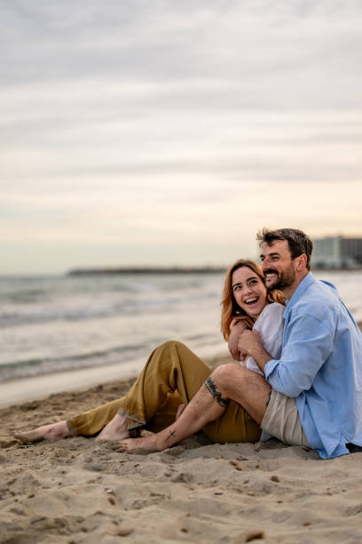 istock Attractive couple cuddling at the beach. 2148135575