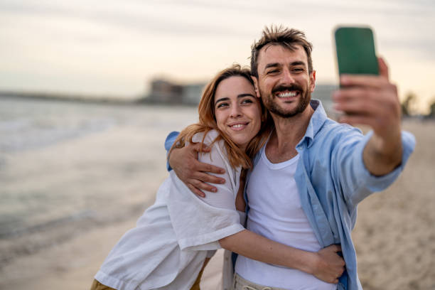 istock Loving young couple taking selfie at the beach 2148135635