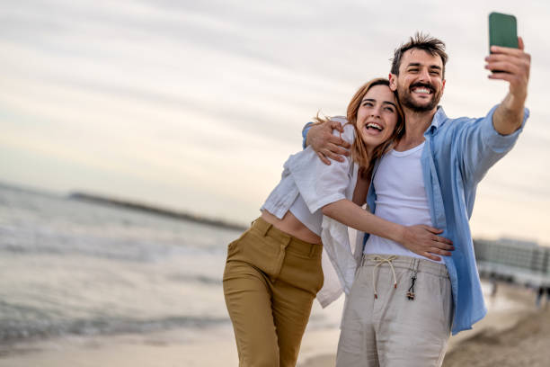 istock Cheerful young couple taking selfie on tropical beach 2148135665