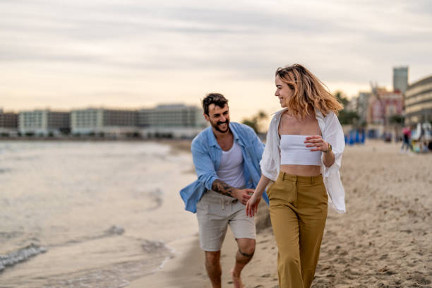 istock Romantic couple having fun on the beach at sunset 2148135792