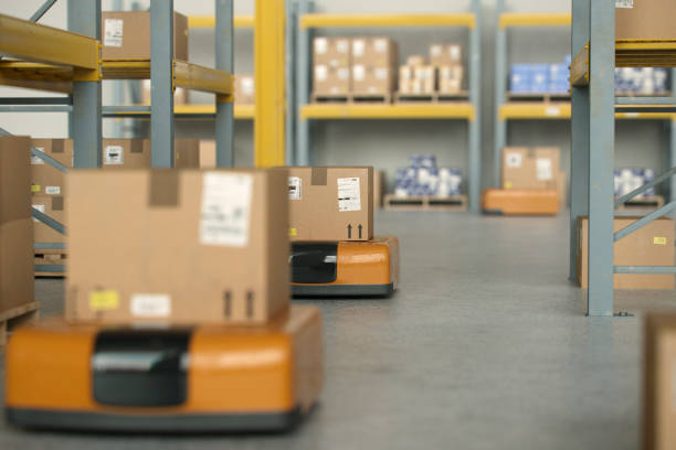AI operated robots working in warehouse moving customer packages for delivery improving efficiency and improving labor cost.
