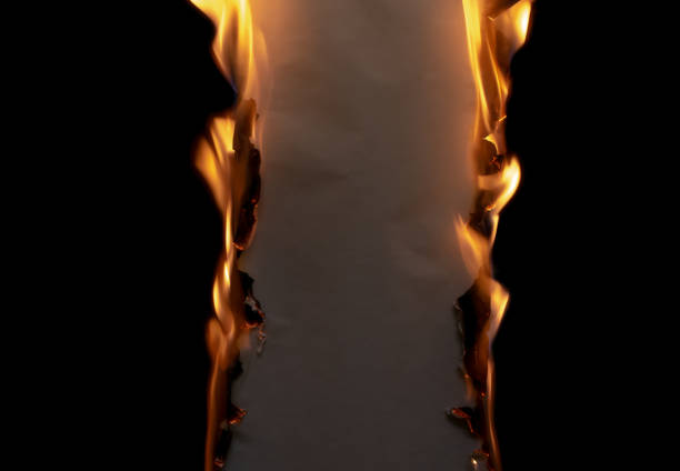 burning paper, glowing edge of paper on a black background