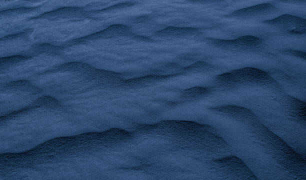 istock blue desert sand shaped into waves by the wind 2148136737