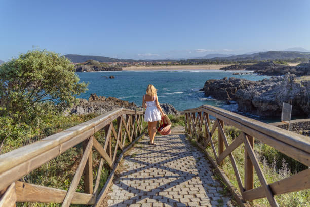 istock Cute woman goes to the beach 2148137759