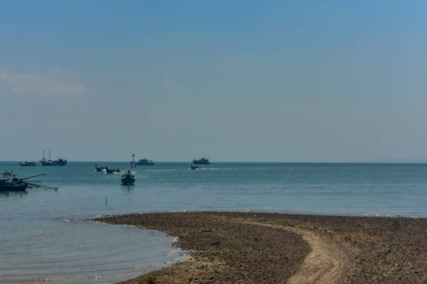 istock Multiple long tail boats in Andaman sea with a beach. 2148138413