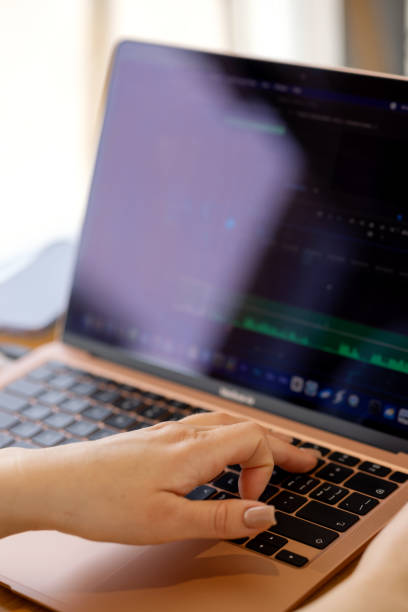 Woman's hand on a Macbook Air laptop keyboard