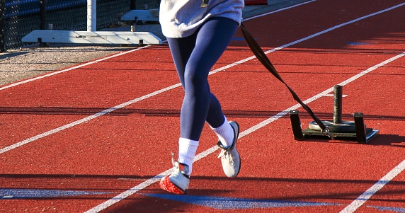 Front view of a runner pulling a sled with weight  on top