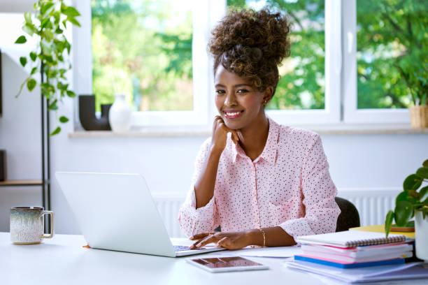 istock Beautiful woman working at home on laptop 2148141165