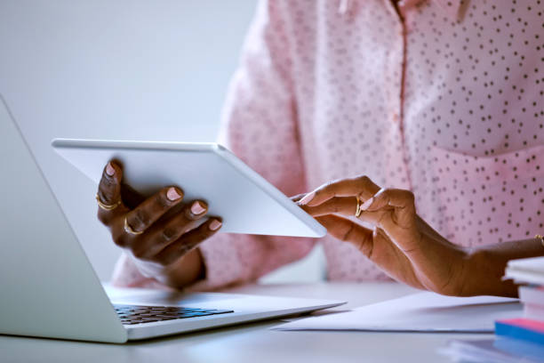 istock Woman using digital tablet, close up of hands 2148141485