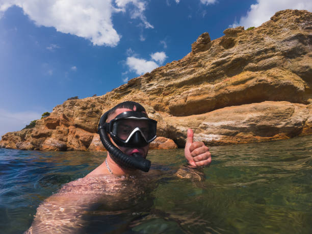 istock A man snorkels at sea in Greece. Snorkeling. 2148141674