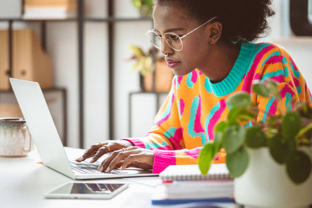 istock Young woman working at home, using laptop 2148141956
