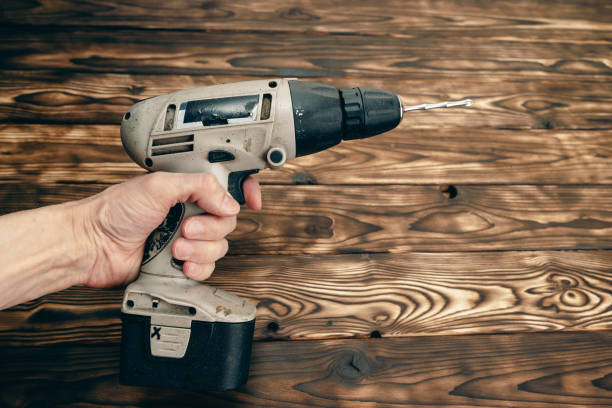 istock person holding a drill in their hand, preparing to use it for a construction or DIY project 2148144766