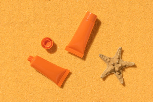 istock Two plastic tubes of sunscreen and a starfish on a sandy background. 2148144777