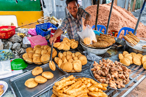 Cambodian man selling snacks in Siem Reap, Cambodia