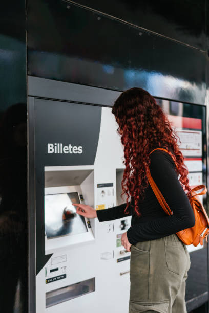 istock Unrecognizable woman buying tickets at an automatic machine 2148146231