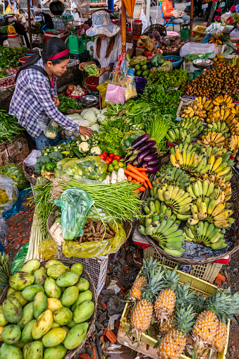 Cambodian women selling fresh fruits and vegetables on a local market in Siem Reap, Cambodia