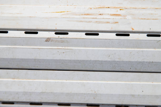 Detail of old and disused white roller blinds. Close-up abstract image.