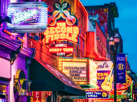 Neon signs lit up at night on Broadway Street in Nashville, Tennessee