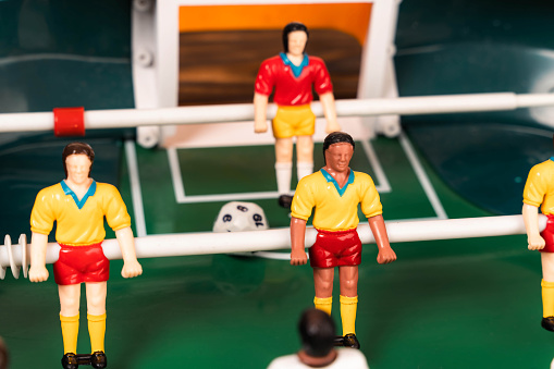 A collection of miniature toy figurines depicting soccer players in various poses, showcasing different teams and players in action on the field.