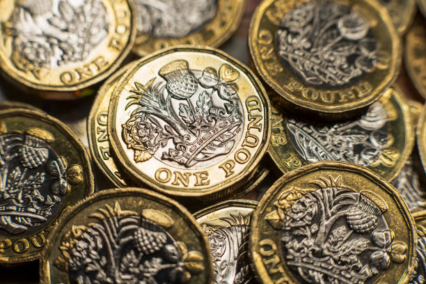 GB Pound Sterling British currency close-up. Tax, Inflation, Economics themes. british currency stock pictures, royalty-free photos & images