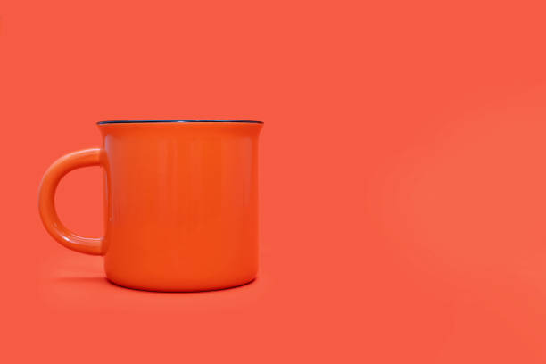 istock Orange mug on a bright orange background with free space for text 2148151128