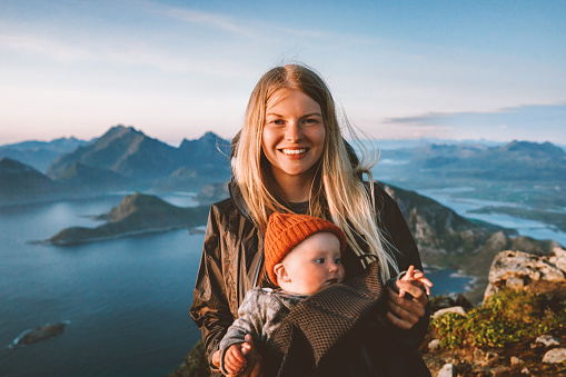 Mother traveling with baby healthy lifestyle outdoor family travel in Norway summer vacations happy smiling woman with infant child in mountains of Lofoten islands active tour, Mothers day
