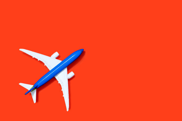 istock Aircraft model on a orange background. Tourism or freight transport concept 2148151276